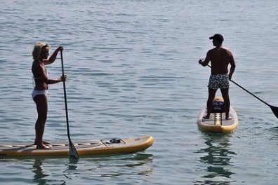 a group of people riding on the back of a boat in the water