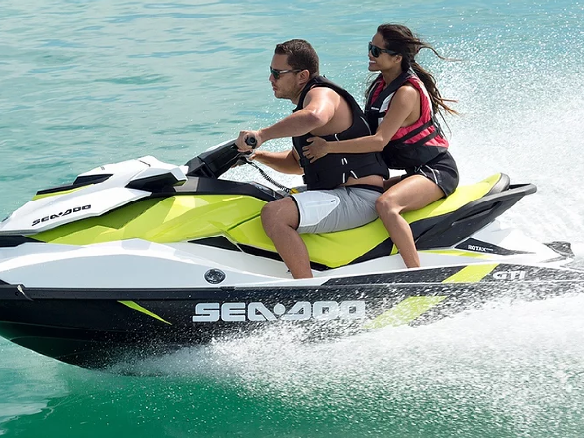 a person riding on the back of a boat in the water